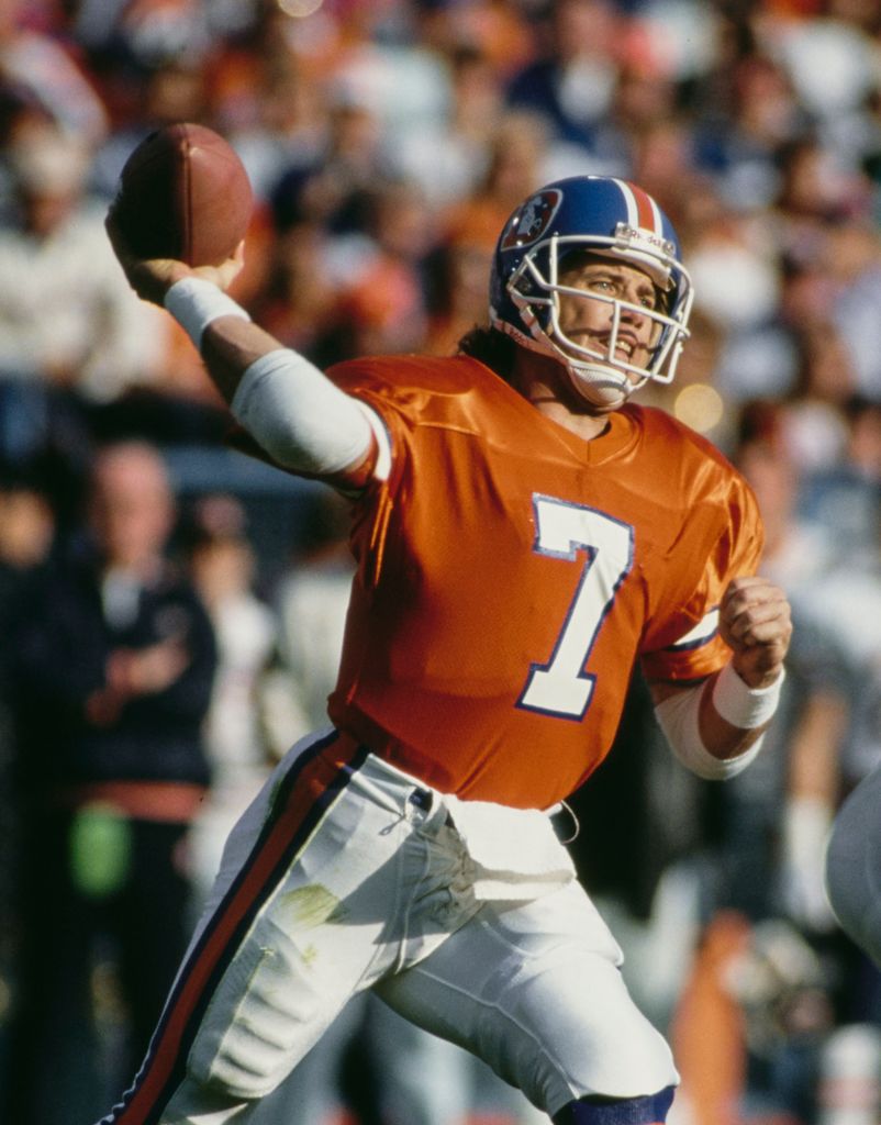 John Elway #7, Quarterback for the Denver Broncos throws the football downfield in 1990