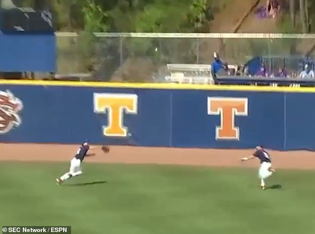 Ole Miss outfielders Isaac Humphrey (L) and Ryan Moerman (R) chased down a fly ball