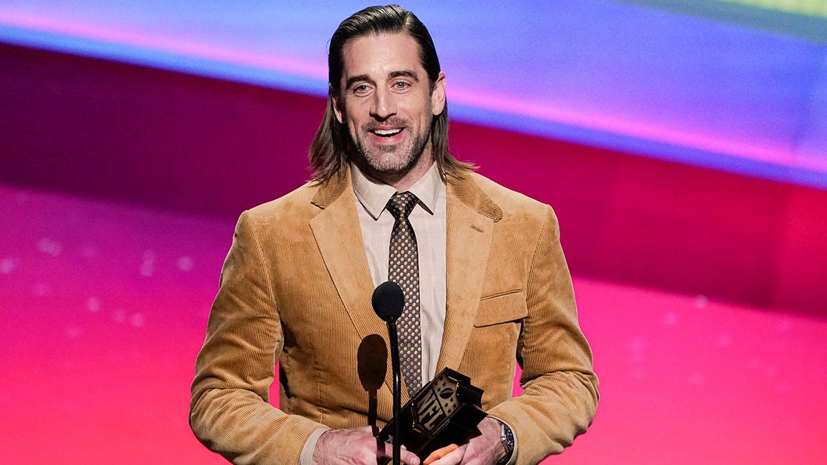 Aaron Rodgers receives an award