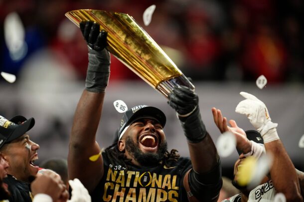 Jeremiah Smith of Ohio State hoists the national championship trophy.