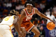 Texas guard Tre Johnson (20) drives against Tennessee guard Jahmai Mashack (15) during the...