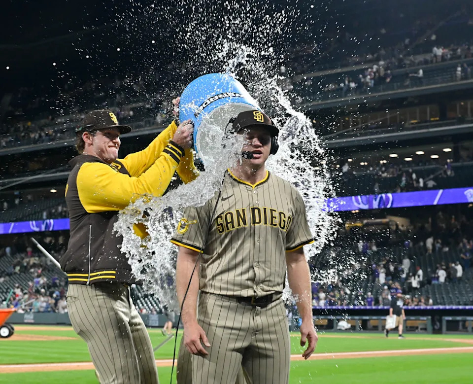 San Diego Padres pitcher Stephen Kolek (32) gets water dumped on him after his complete game and shutout of the Colorado Rockies at Coors Field. John Leyba-Imagn Images