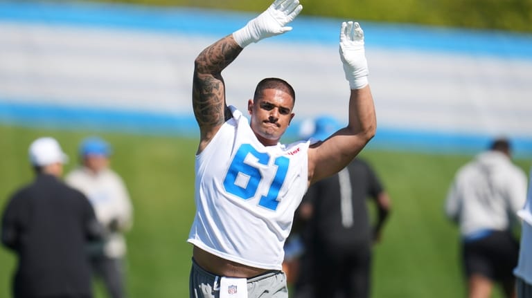 Detroit Lions defensive lineman Ahmed Hassanein (61) stretches during the...