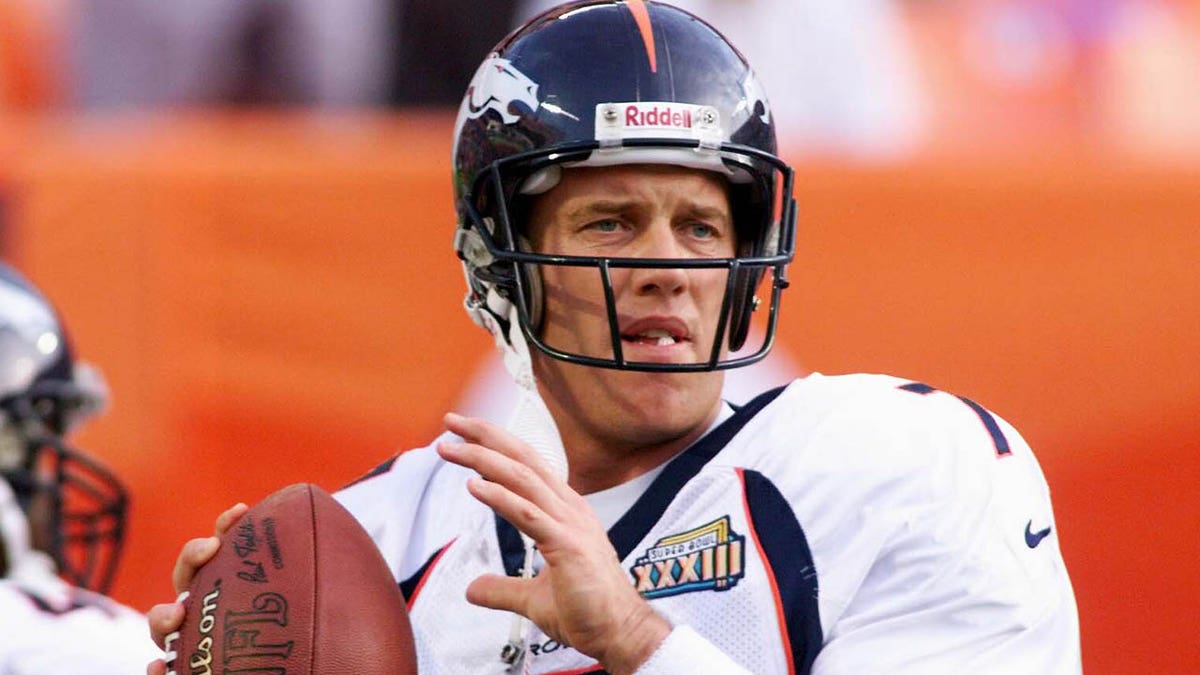 John Elway warms up