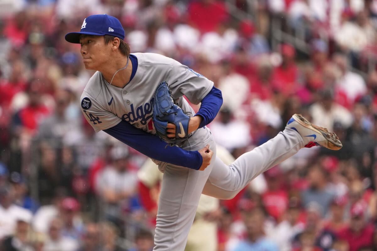 Dodgers starting pitcher Yoshinobu Yamamoto delivers against the Cardinals in the first inning Saturday.
