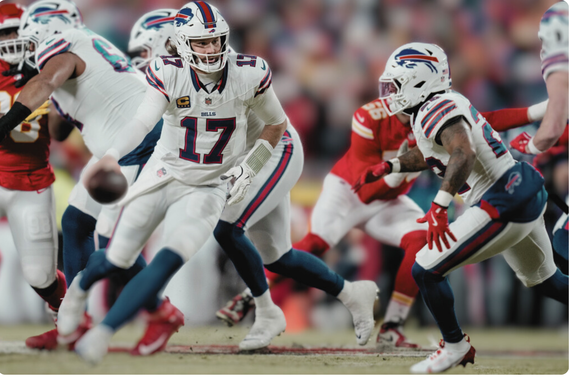 Buffalo Bills quarterback Josh Allen (17) hands the ball off to Buffalo Bills running back Ty Johnson (26) during the first half of the AFC Championship NFL football game.