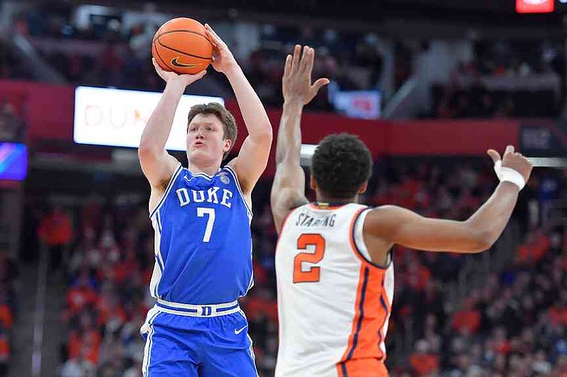 FILE - Duke guard/forward Kon Knueppel (7) shoots over Syracuse guard J.J. Starling (2) during the first half of an NCAA college basketball game in Syracuse, N.Y., Wednesday, Feb. 5, 2025. (AP Photo/Adrian Kraus, File)