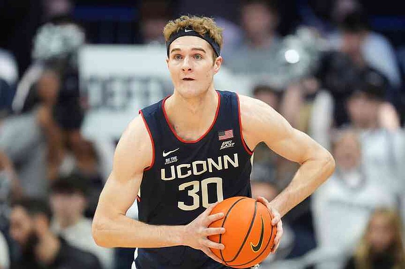 FILE - Connecticut forward Liam McNeeley (30) plays against Butler in the first half of an NCAA college basketball game in Indianapolis, Saturday, Dec. 21, 2024. (AP Photo/Michael Conroy, File)