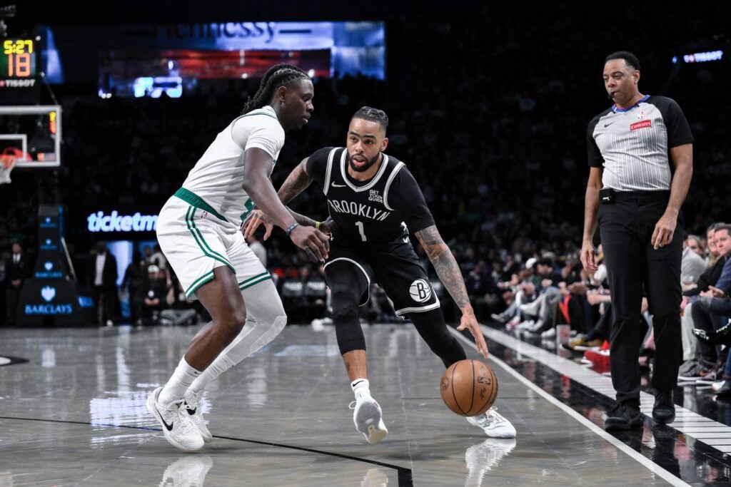 Brooklyn Nets guard D'Angelo Russell (1) drives to the basket while being defended by Boston Celtics guard Jrue Holiday (4) during the first half at Barclays Center.
