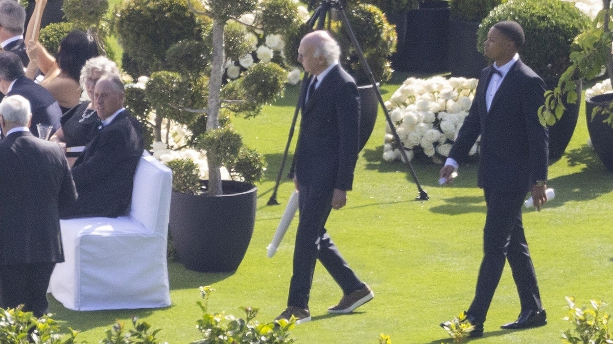 Larry David walks to his seat