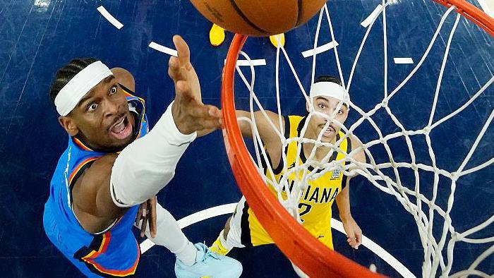 Shai Gilgeous-Alexander of the Oklahoma City Thunder attempts a lay-up against the Indiana Pacers in game four of the NBA Finals
