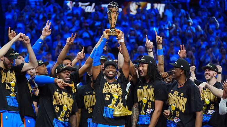 Oklahoma City Thunder guard Shai Gilgeous-Alexander (centre) holds up the MVP trophy
